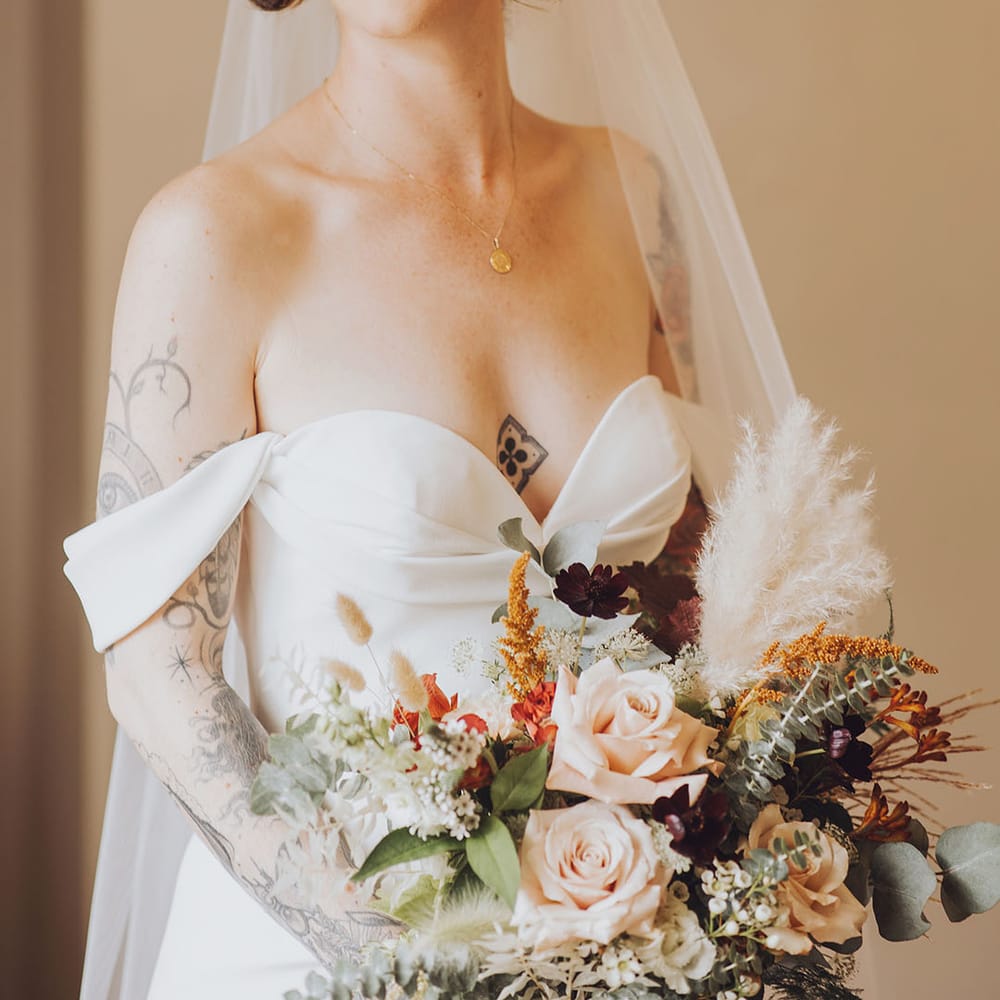 Bride wears red lipstick and Vera Wang wedding dress with sweetheart neckline and off the shoulder styling 
