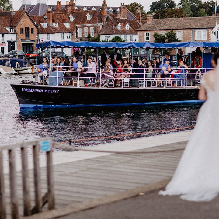 The wedding guests travel by boat to the tipi wedding reception at Culden Faw Estate 