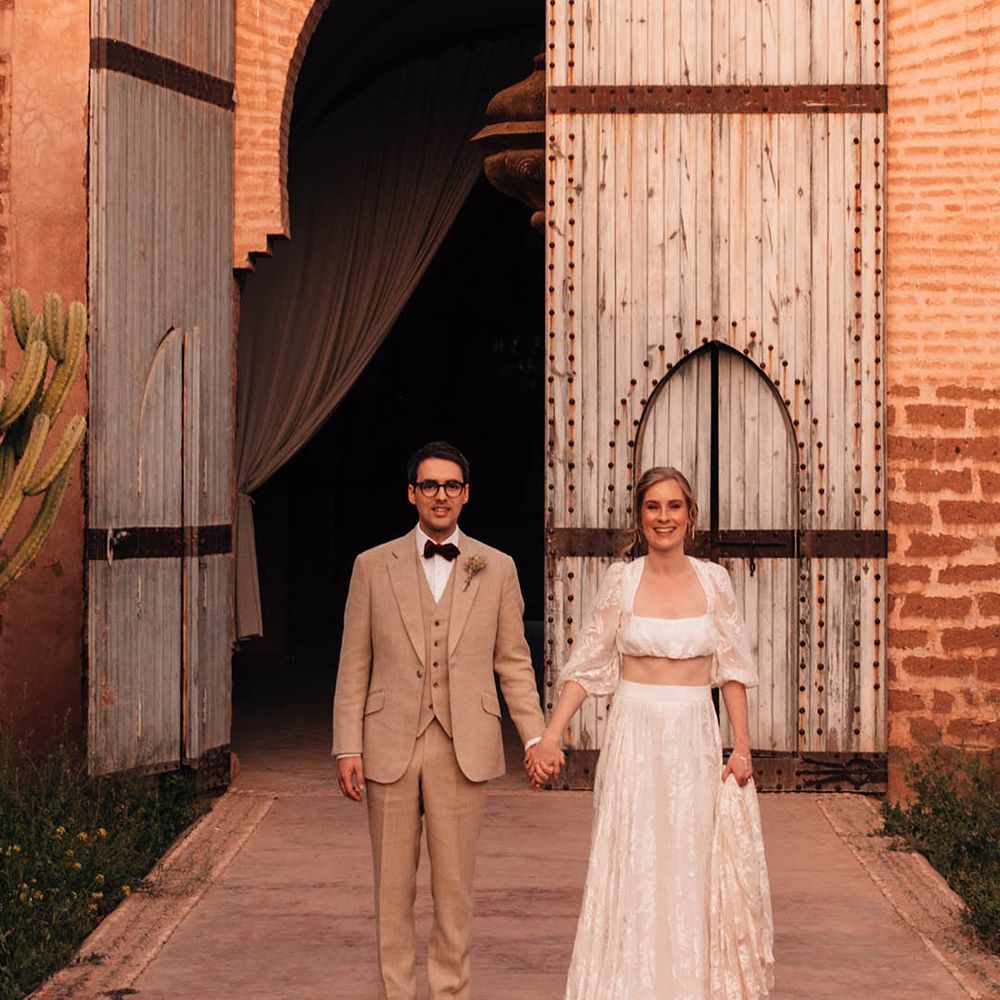 Stunning bride in lace bridal separates with groom in three piece cream suit 