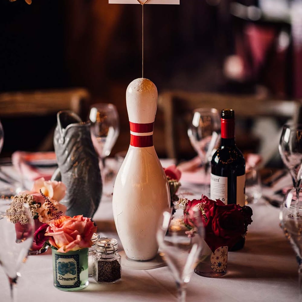 Fun bowling pin wedding table centrepiece with table number sign 