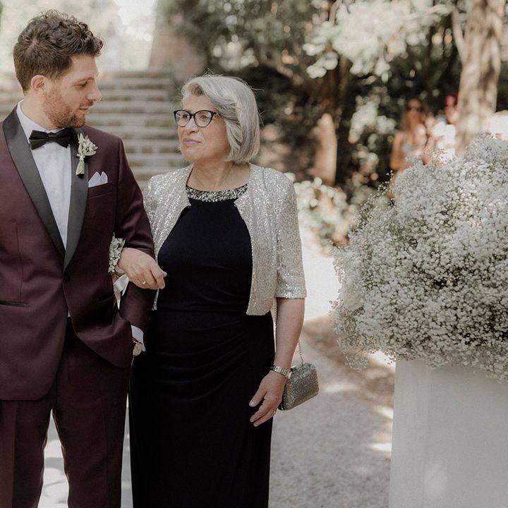 Mother of the groom walking the groom down the aisle 