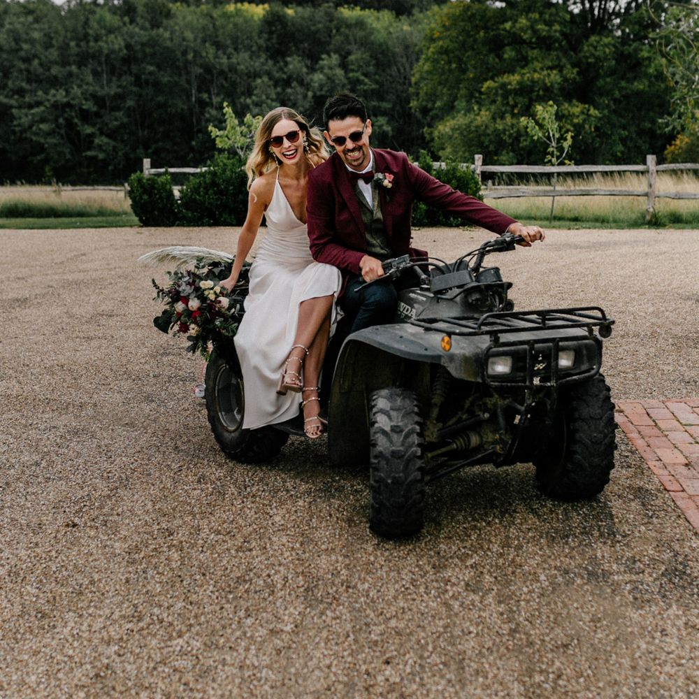 Stylish bride and groom riding a quad bike