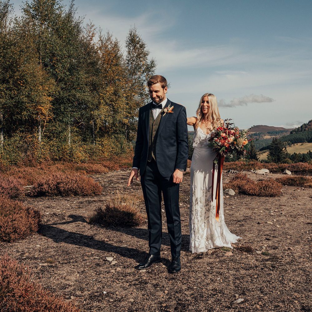 Bride & groom walk through the countryside in Scotland