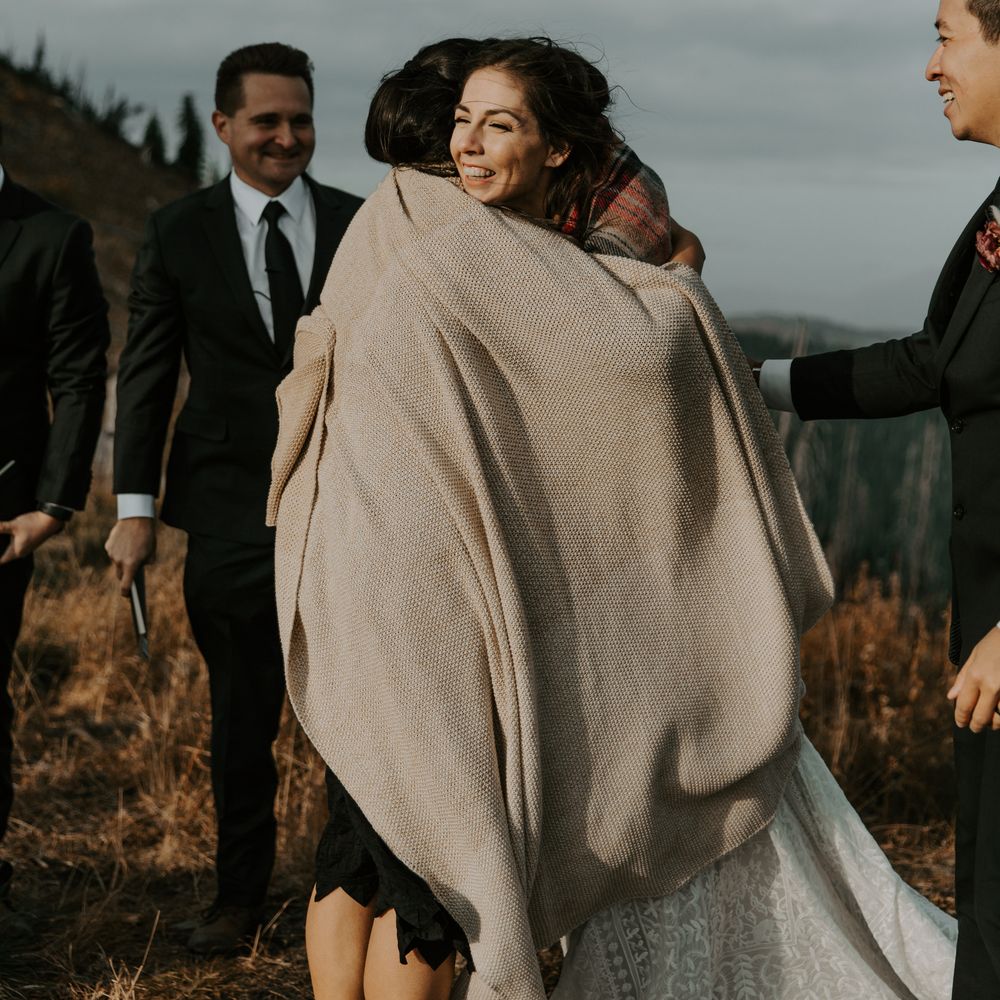 Bride hugs wedding guest during elopement 