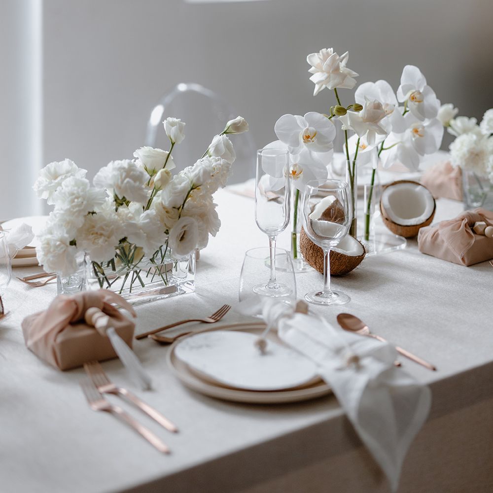 All white floral centrepieces at minimalist Asian Lesbian wedding reception 