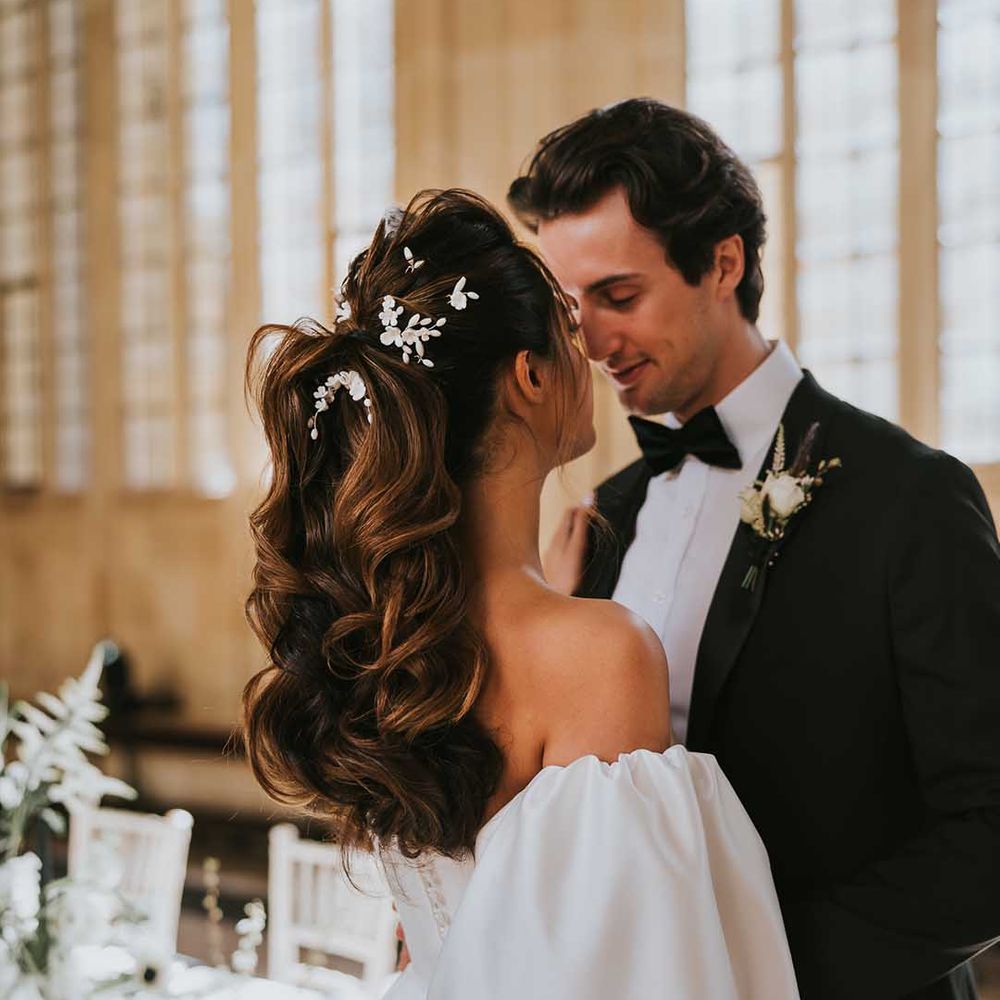 Bride with a wavy high ponytail wedding up do with white hair pins 