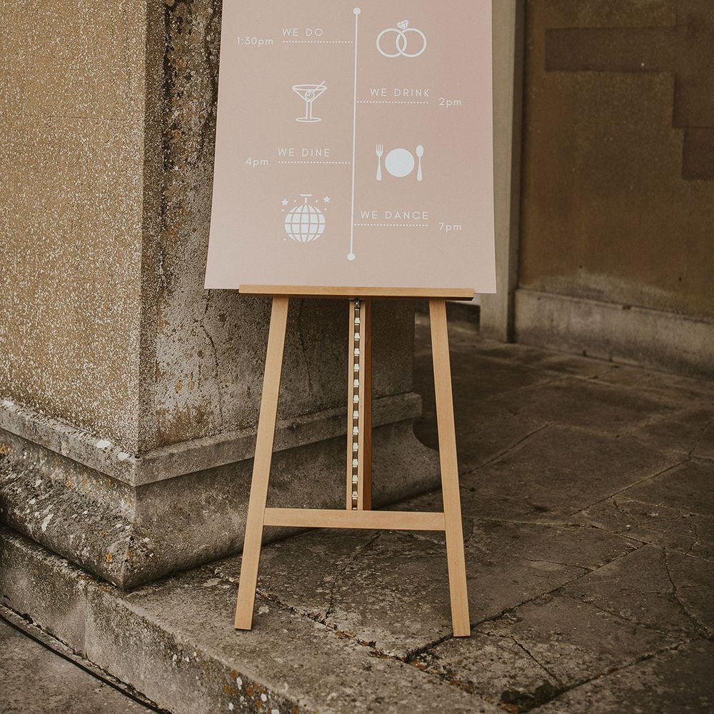 Pale pink wedding stationery complete with white writing and illustrations 