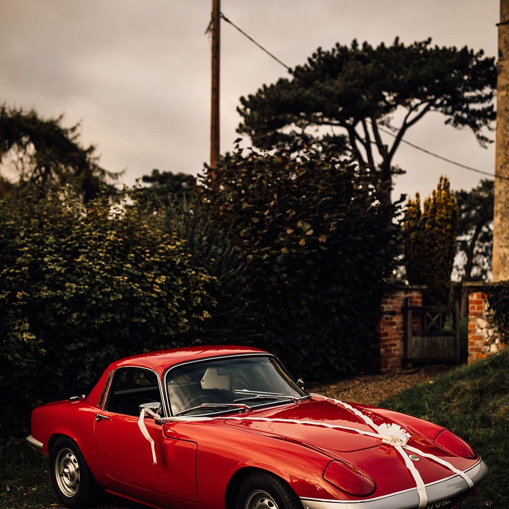 Red vintage wedding car at Oxnead Hall wedding venue