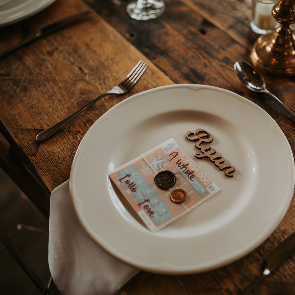 Rustic wooden wedding table setting with white plate, wooden laser cut table place name and scratch card