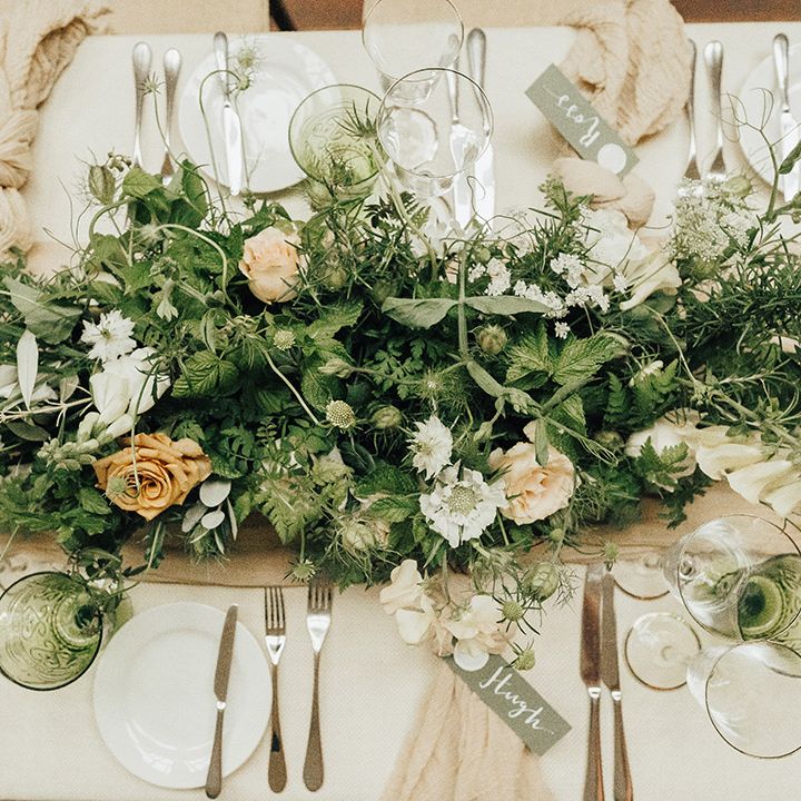 Birdseye view of an elegant table setting with floral centrepiece of flowers and foliage 