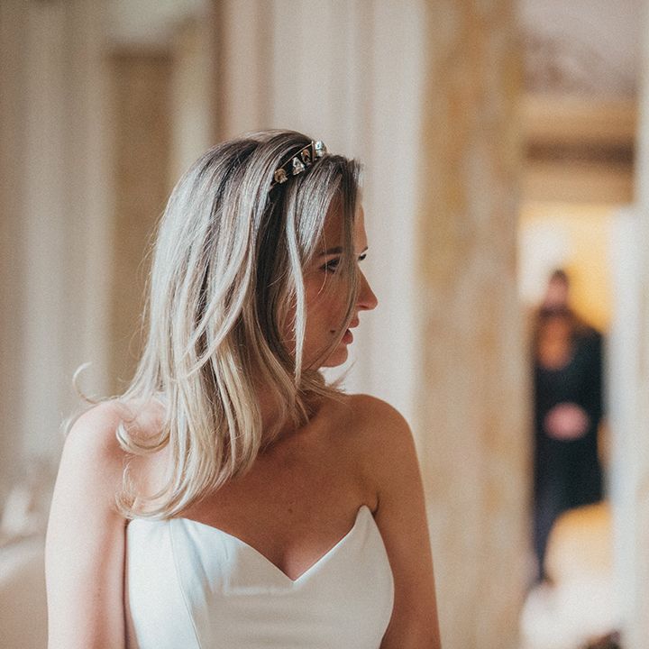 Bride wears her blonde hair in blow out complete with Nefertiti Crown and Suzanne Neville gown with sweetheart neckline 