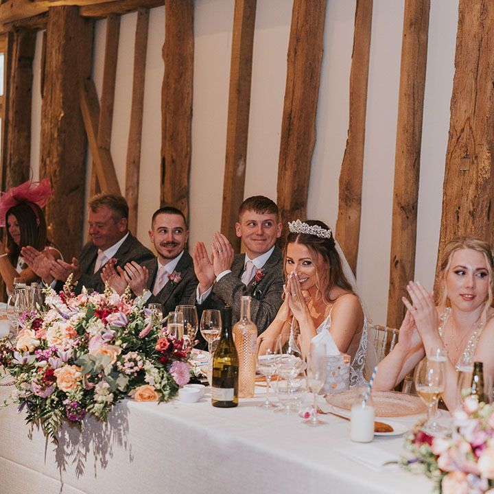 Guests call and applaud as speeches are read out at the reception