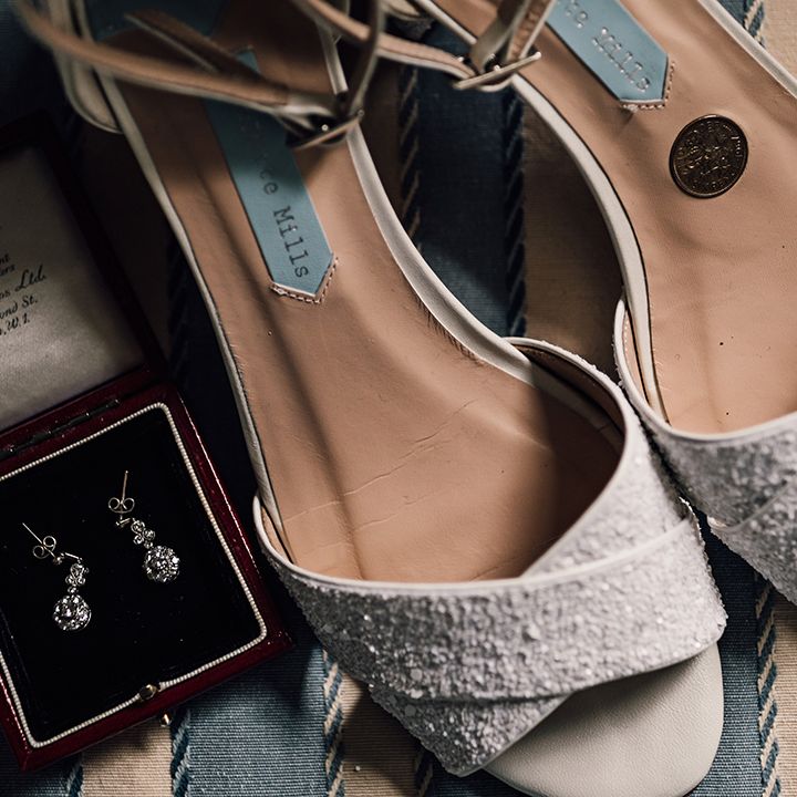 White glitter wedding shoes from Charlotte Mills with silver diamond earrings