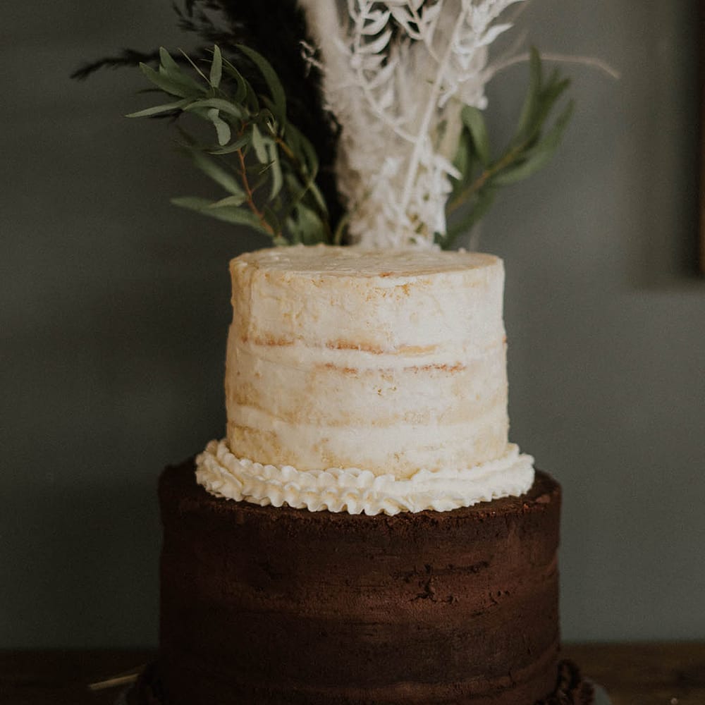 Two tier semi naked two tone chocolate and vanilla wedding cake 