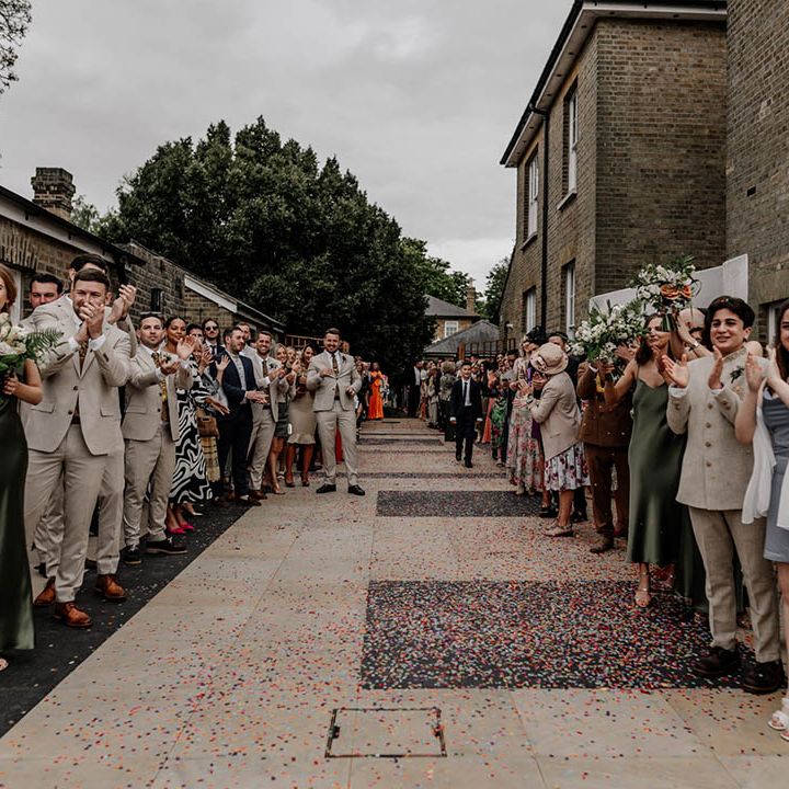 Wedding guests clapping at confetti exit 