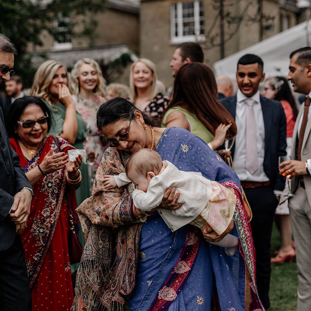 Multicultural back garden wedding with wedding guest enjoying the celebrations 