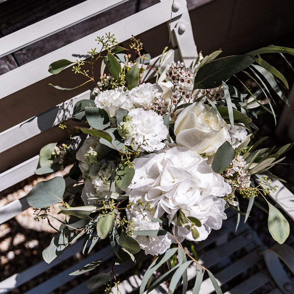 White bridal bouquet with roses and green foliage 