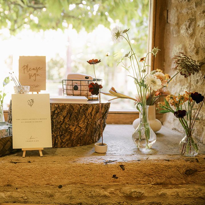 Polaroid wedding guest book idea on tree trunk stands for rustic barn wedding 