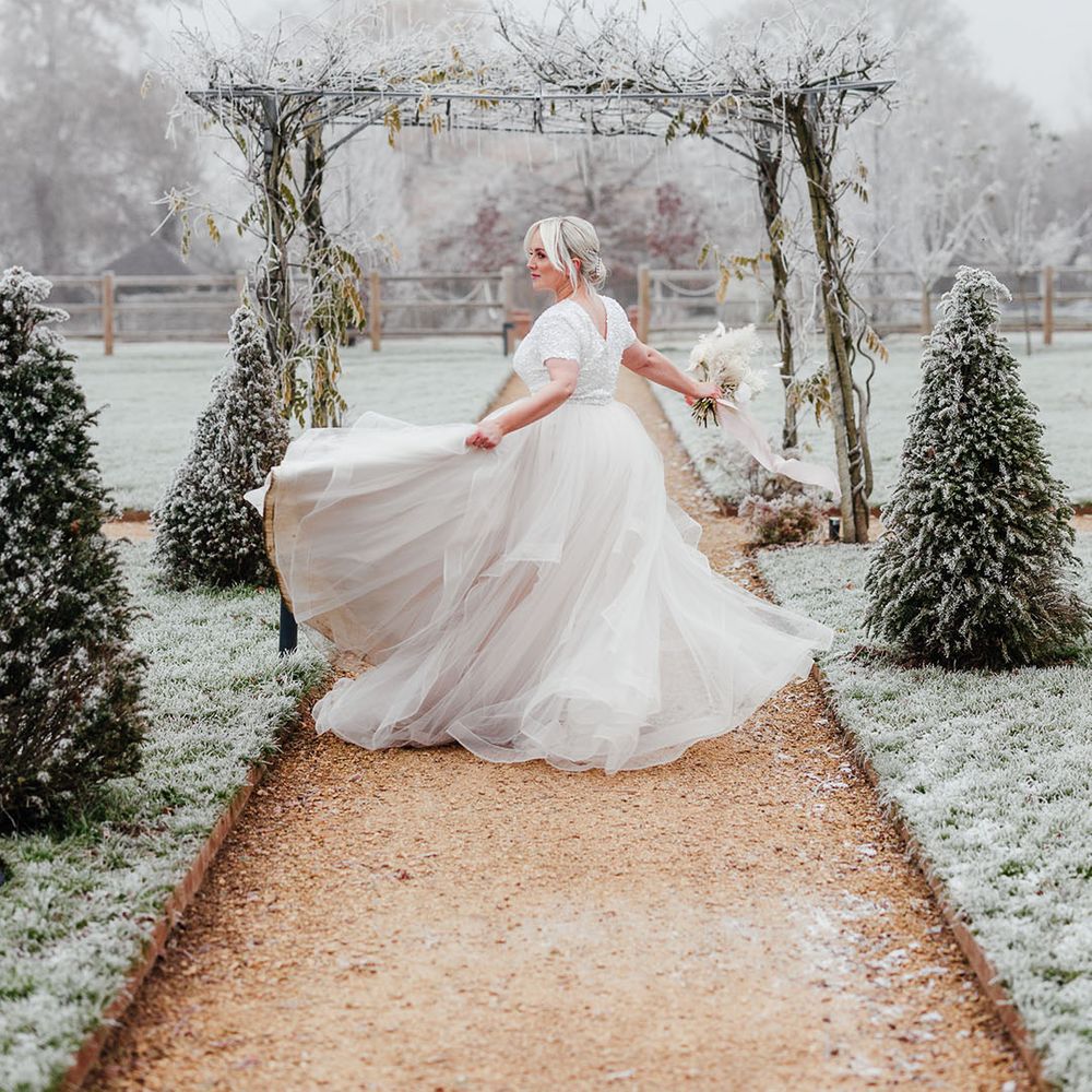 Bride in princess style bridal separates spinning her skirt around at the grounds of Silchester Farm wedding venue