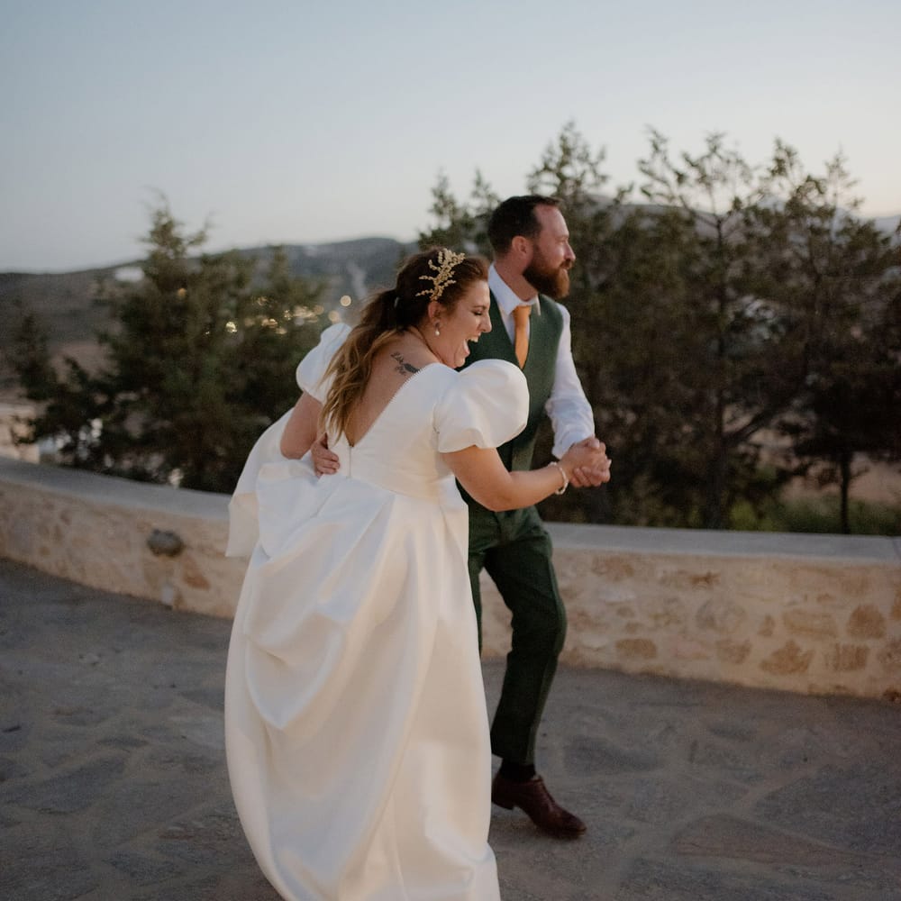 Bride and groom share fisrt dance during dusk at private villa wedding in Greece