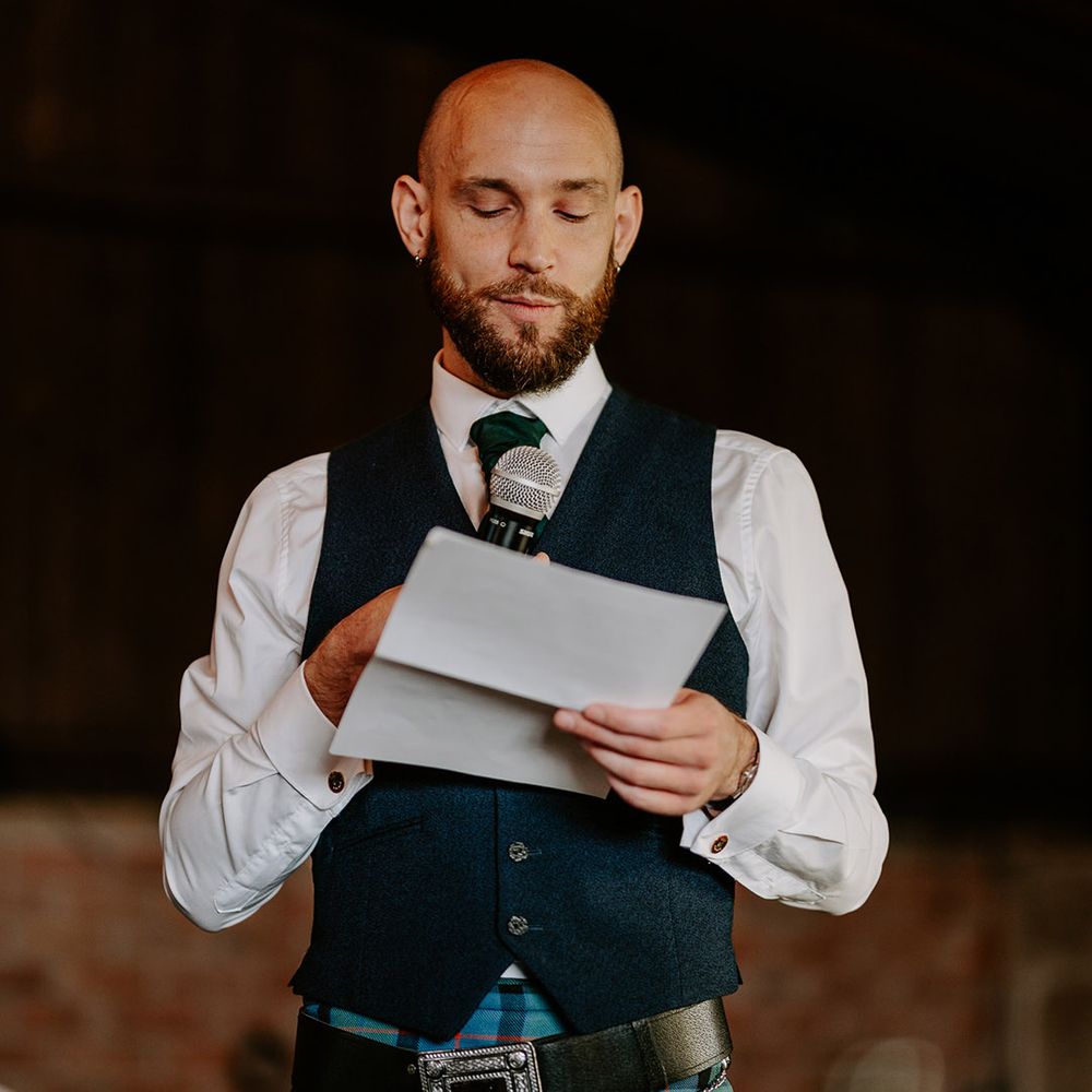 Groomsman reads out wedding speech at the wedding 