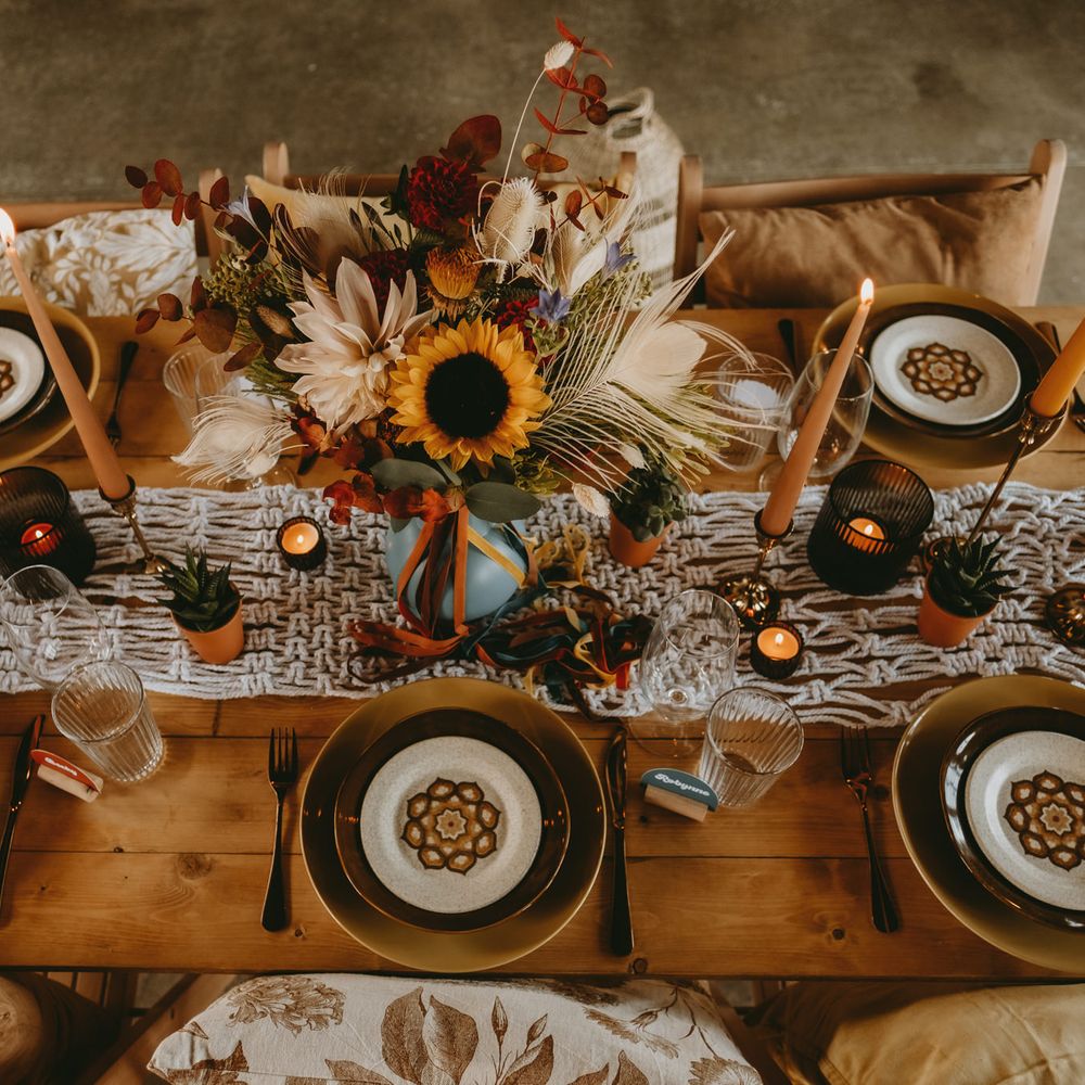 Macrame table runner, succulents and candles decorating the wedding table 