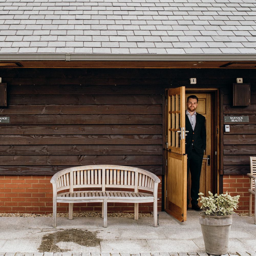 Bride & groom pose in doorway 