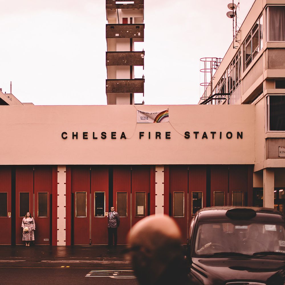 Bride & groom stand outside the Chelsea Fire Station on the morning of their wedding