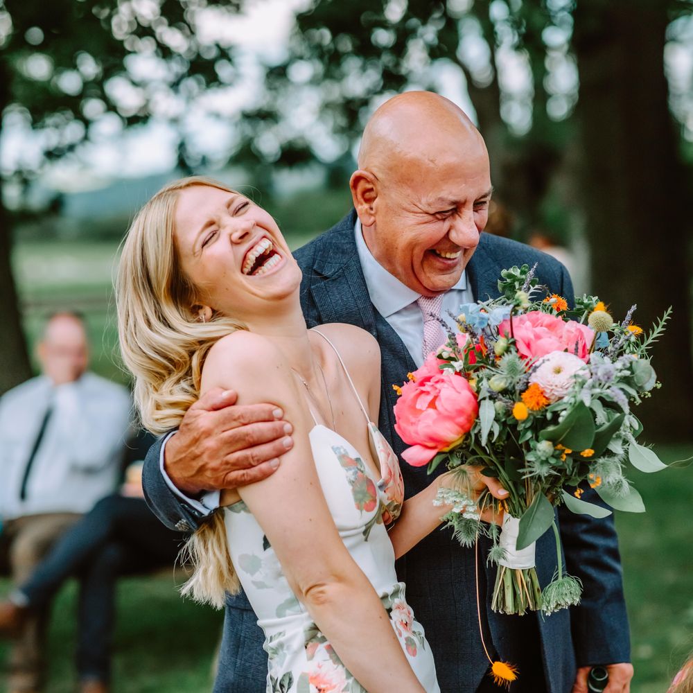 Wedding guests laugh together at Park Farm wedding