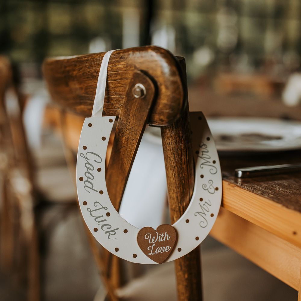 White good luck horseshoe chair hanging for rustic wedding
