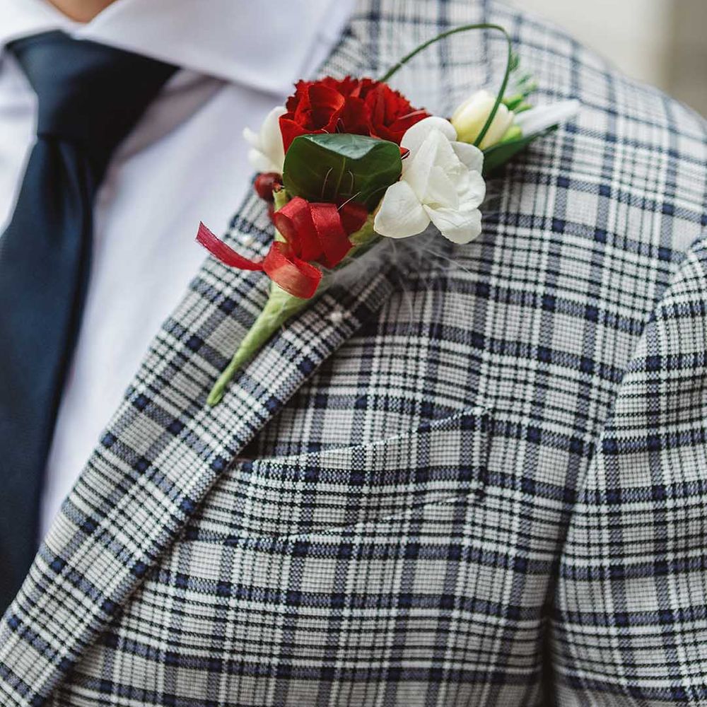 Floral buttonhole with white and red blooms 