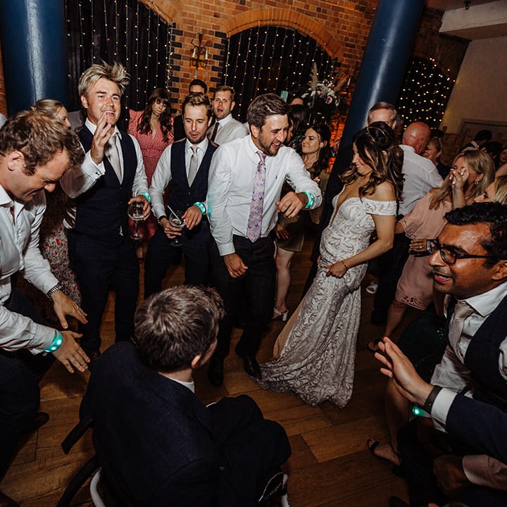 Everyone dances at the wedding reception with their light up wristband wedding favours