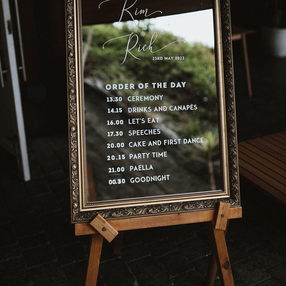 Gold framed mirror complete with white writing for Order Of The Day signage on wooden easel 