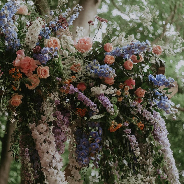 Close up of the stunning pink, white, and blue wildflower decoration for boho outdoor wedding
