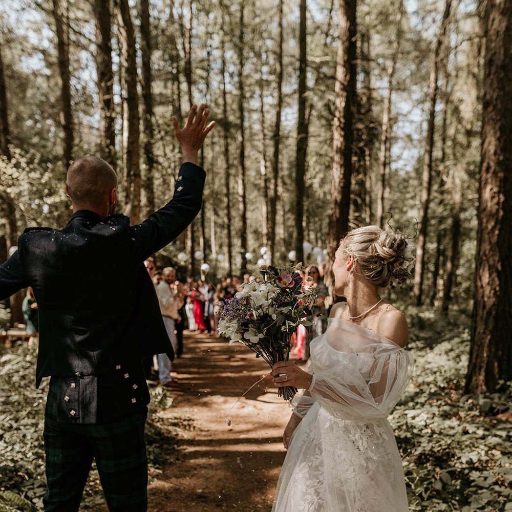 Bride and groom celebrate as they walk back down the aisle together as a married couple