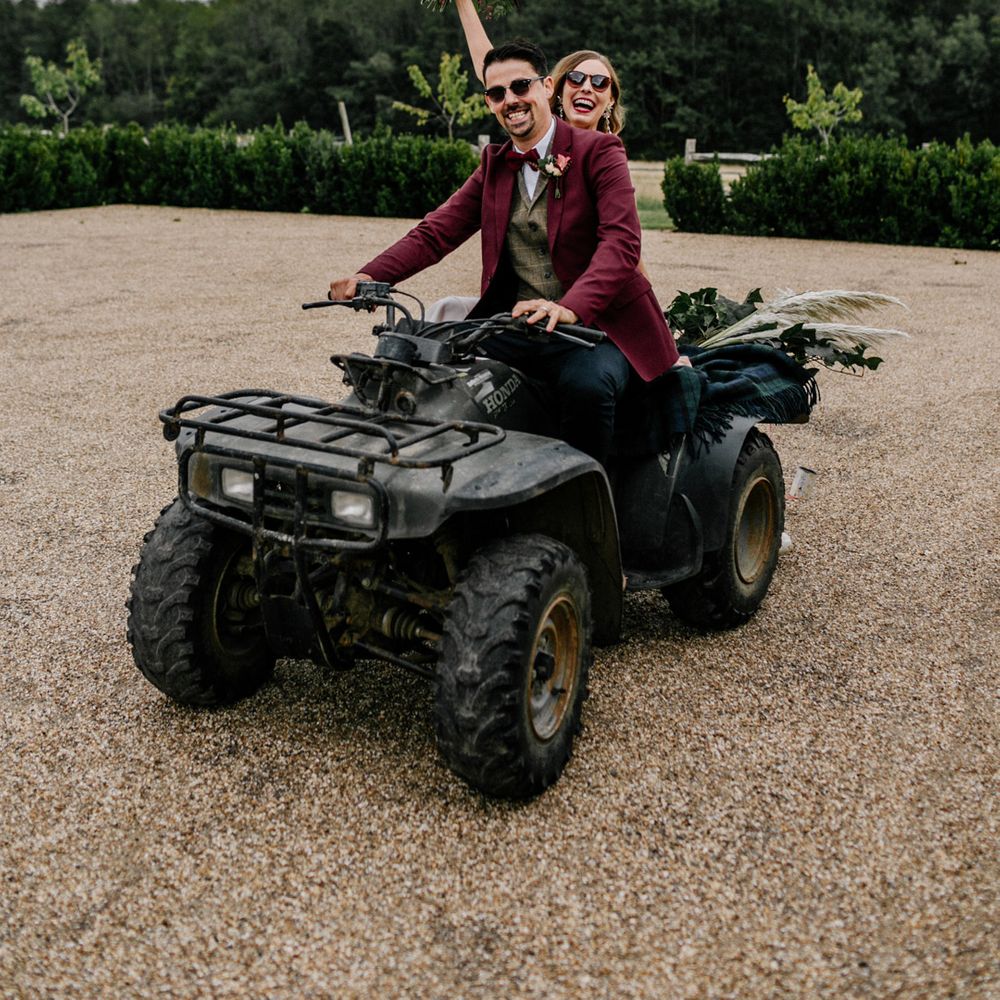 wedding portrait by Epic Love Story of a bride and groom riding a quad bike