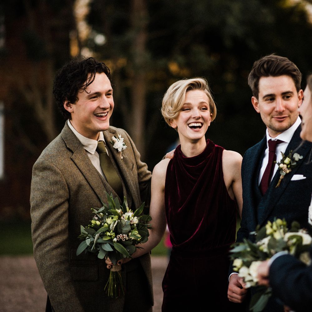 Wedding guests gather outdoors after wedding ceremony