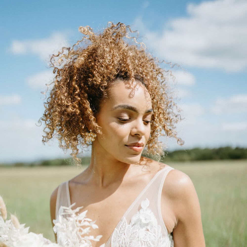 Bride with plunge neckline lace embroidered floral wedding dress and mesh panelling