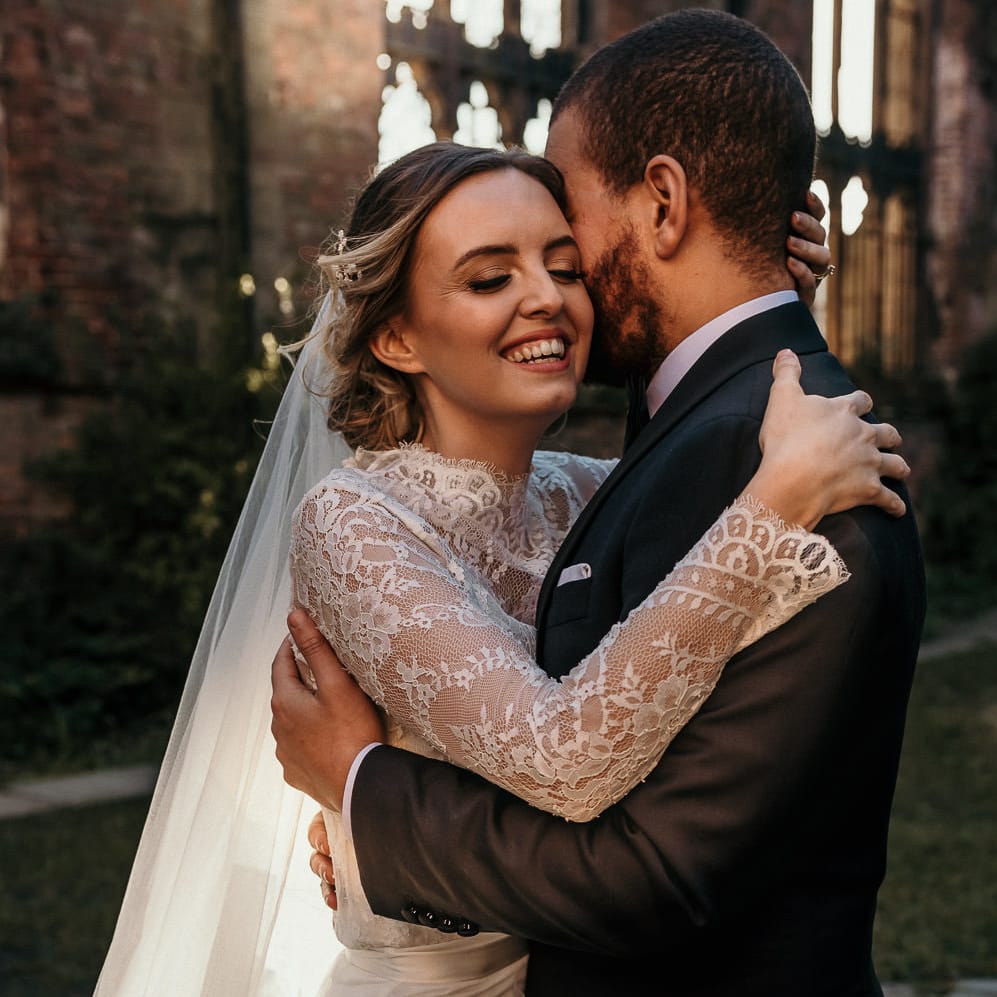 Golden hour portrait with the sun shining through the open air bombed out church 