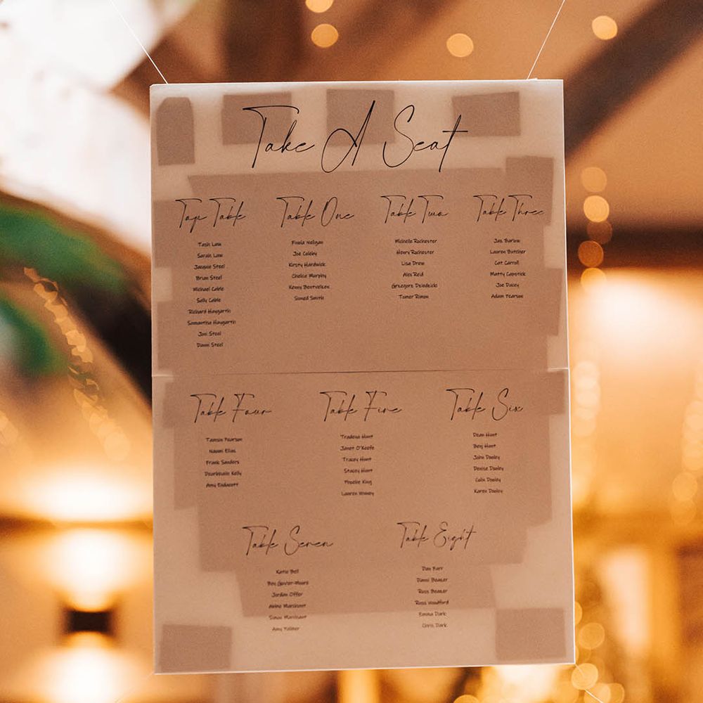 White seating chart hung with string 
