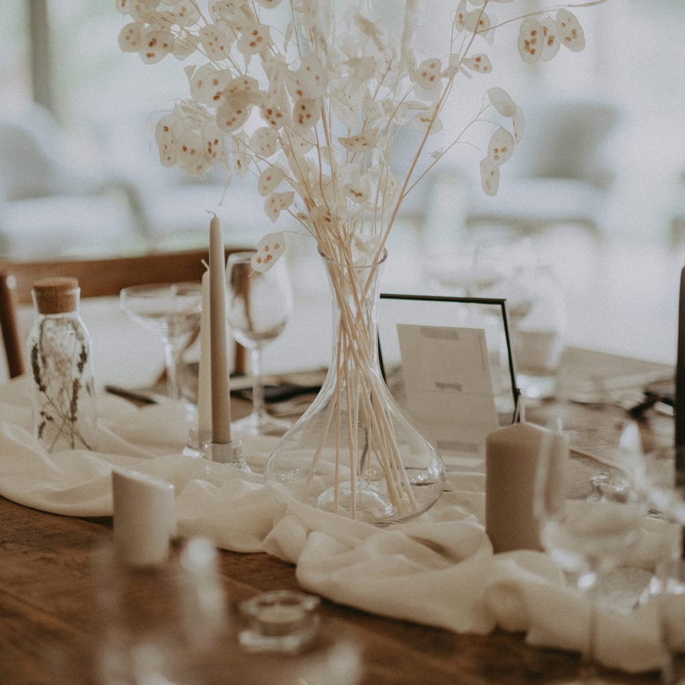 Dried white flower arrangements amongst neutral wedding table decor