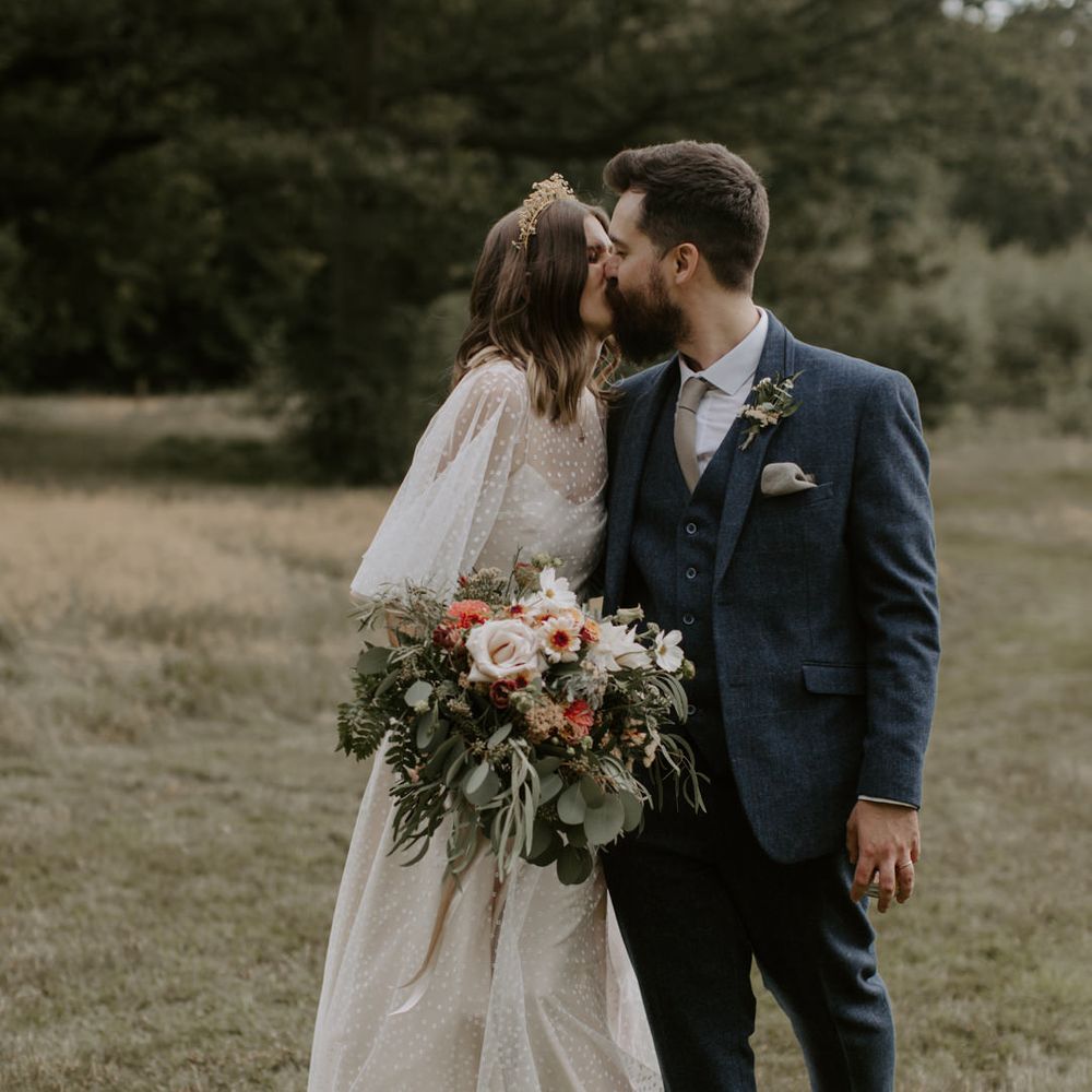 Bride & groom kiss outdoors on their wedding day