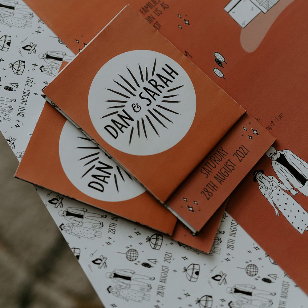 Fun and contemporary stationery invites with burnt orange colour scheme and illustration of couple