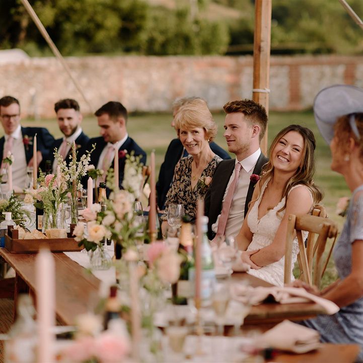 Bride and groom enjoy wedding speeches