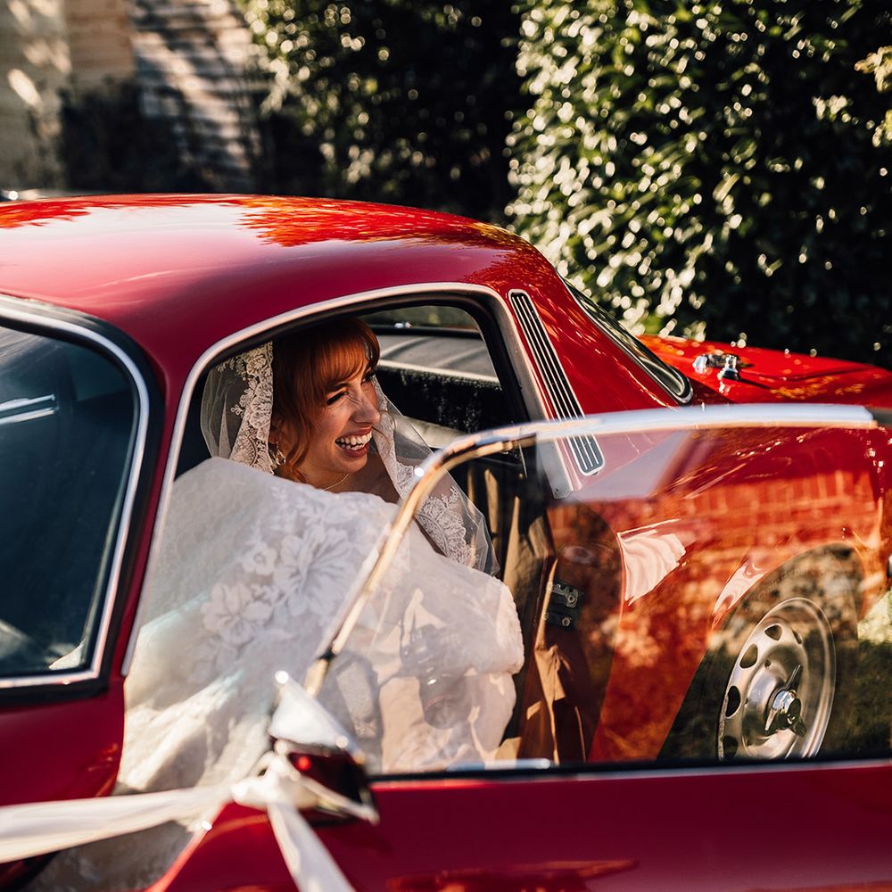 Bride in vintage car at Oxnead Hall wedding venue