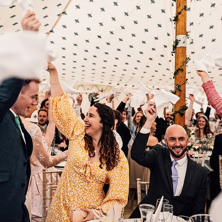 Wedding guests wave their napkins around to celebrate wedding 