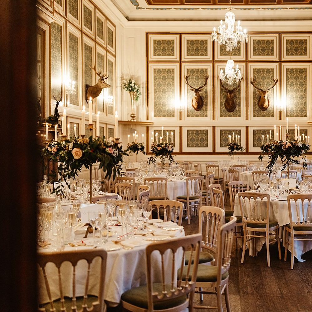 Drumtochy Castle reception complete with round tables, pops of gold colour and floral bouquets 