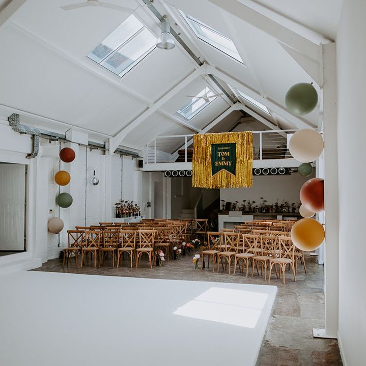 Gold streamer hangs from ceiling complete with velvet banner with personalised names