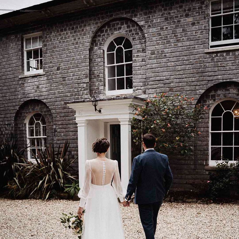 Bride and groom holding hands at Treseren, one of the best UK country house wedding venues