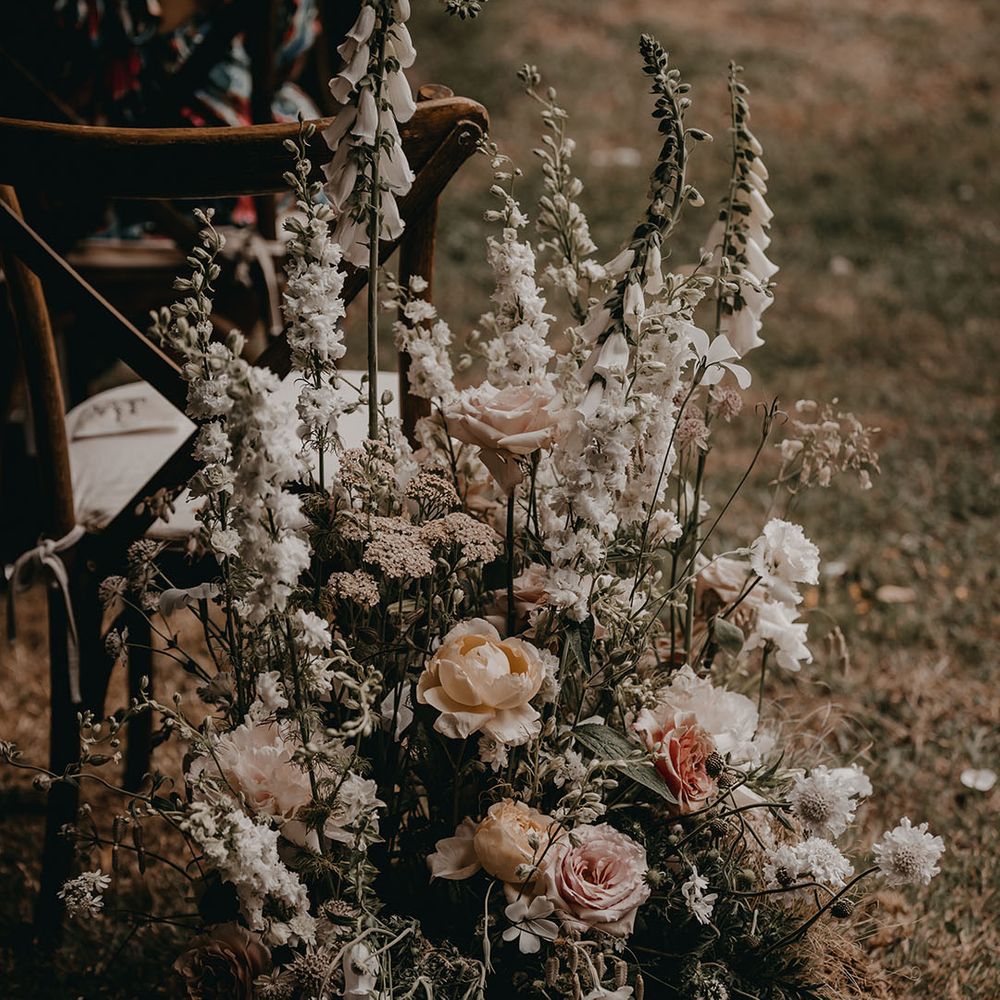Soft blush pink and white wedding flower aisle decorations for the outdoor ceremony 